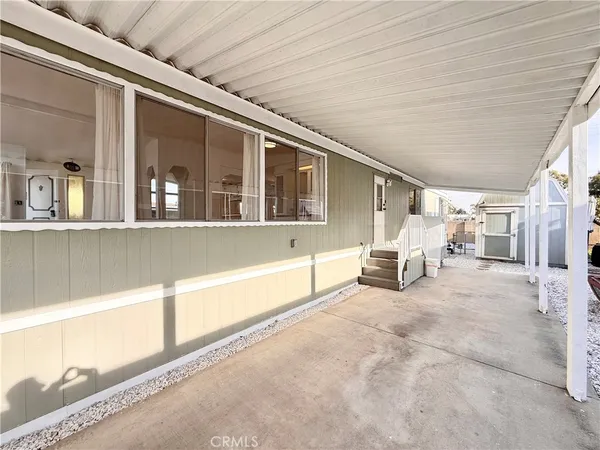 a view of a porch with a table and chairs