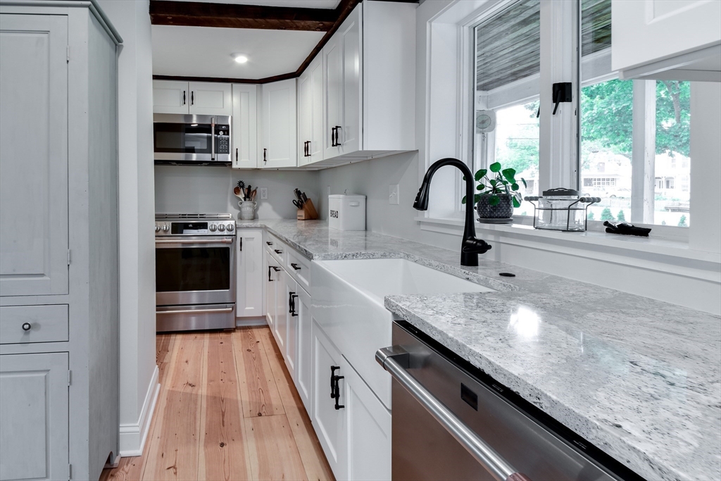 49 Hayden Rowe Street Hopkinton, MA 01748 - Photo 14 of 39 a kitchen with stainless steel appliances granite countertop a sink and stove top oven