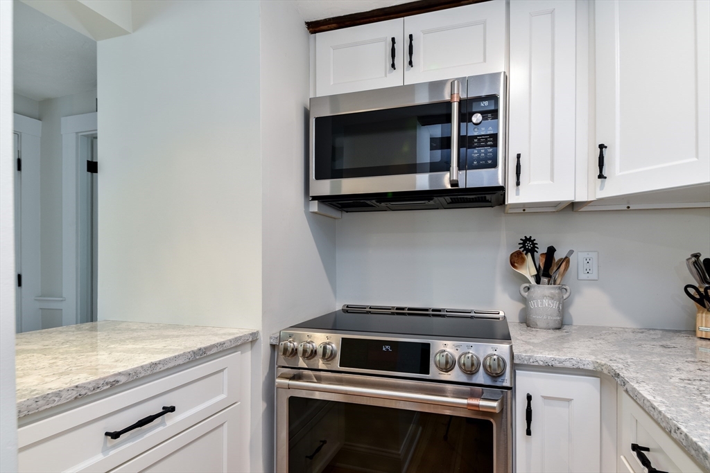 49 Hayden Rowe Street Hopkinton, MA 01748 - Photo 15 of 39 a kitchen with granite countertop white cabinets and stainless steel appliances