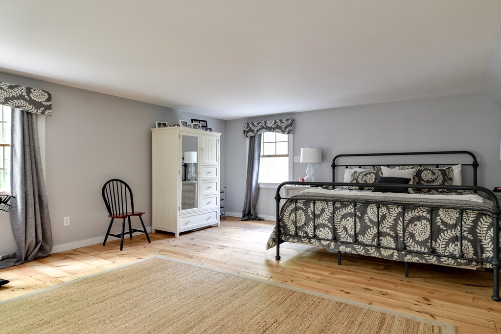 49 Hayden Rowe Street Hopkinton, MA 01748 - Photo 21 of 39 a bedroom with a bed next to a window with chair