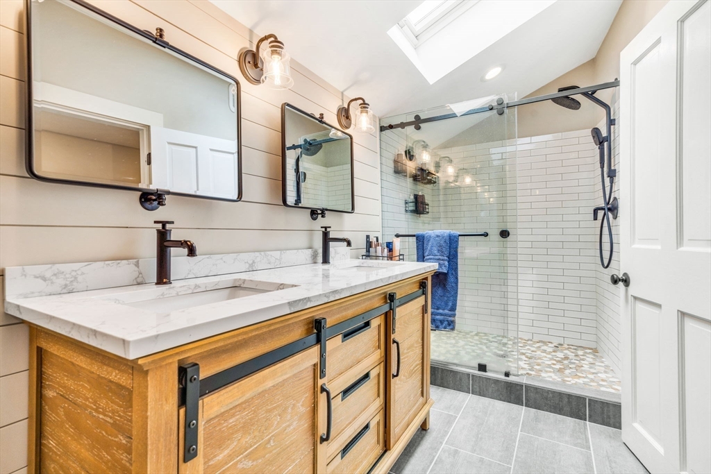 49 Hayden Rowe Street Hopkinton, MA 01748 - Photo 23 of 39 a bathroom with a sink and a mirror