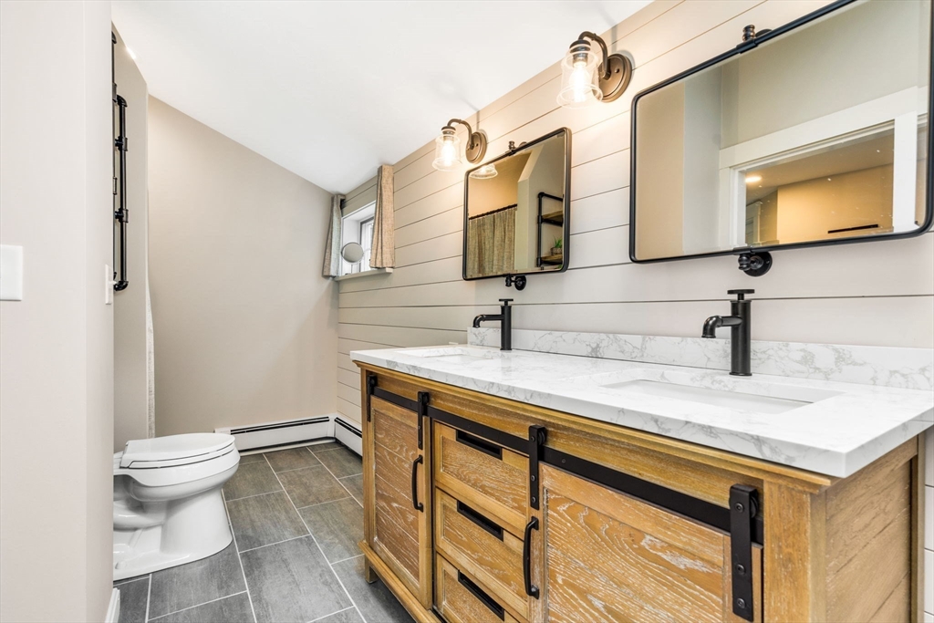 49 Hayden Rowe Street Hopkinton, MA 01748 - Photo 24 of 39 a bathroom with a sink a toilet and mirror