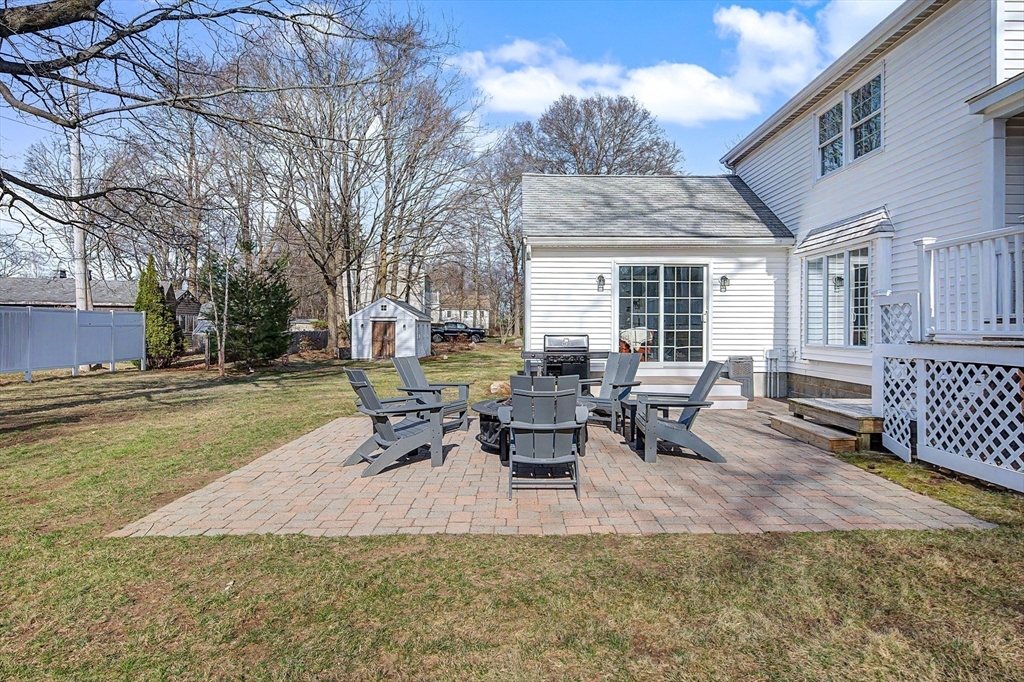 49 Hayden Rowe Street Hopkinton, MA 01748 - Photo 30 of 39 a view of a patio with table and chairs with wooden fence and floor