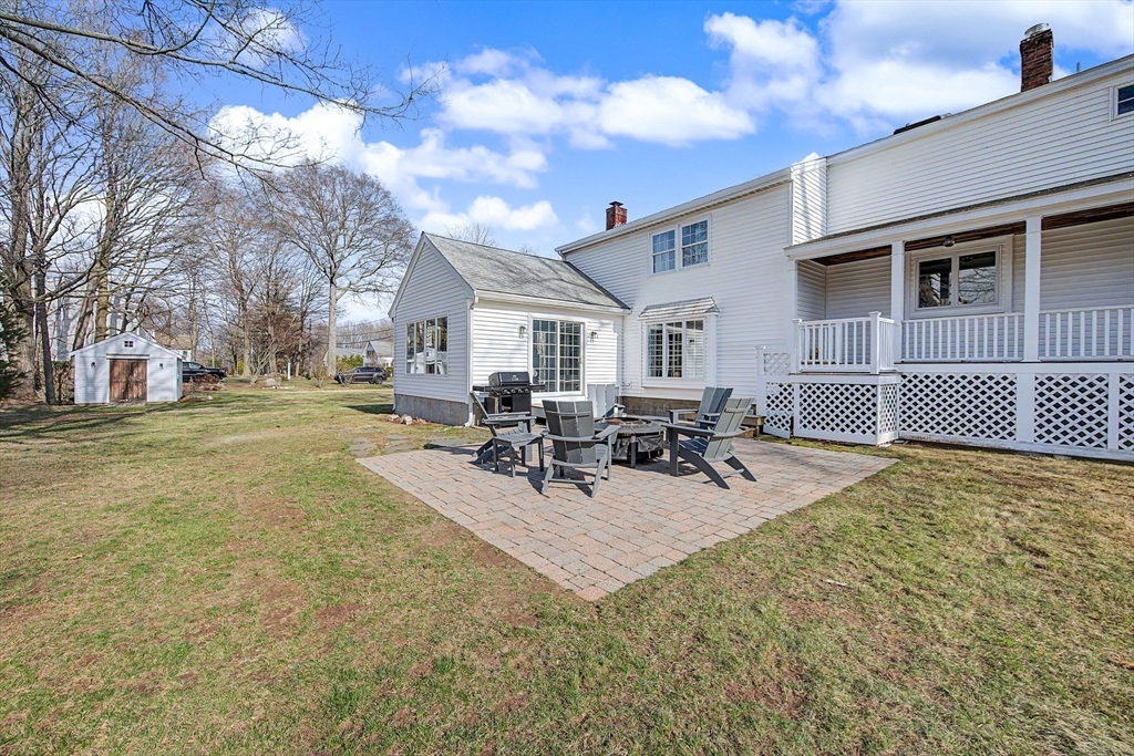 49 Hayden Rowe Street Hopkinton, MA 01748 - Photo 32 of 39 a view of a patio with dining table and chairs with wooden fence