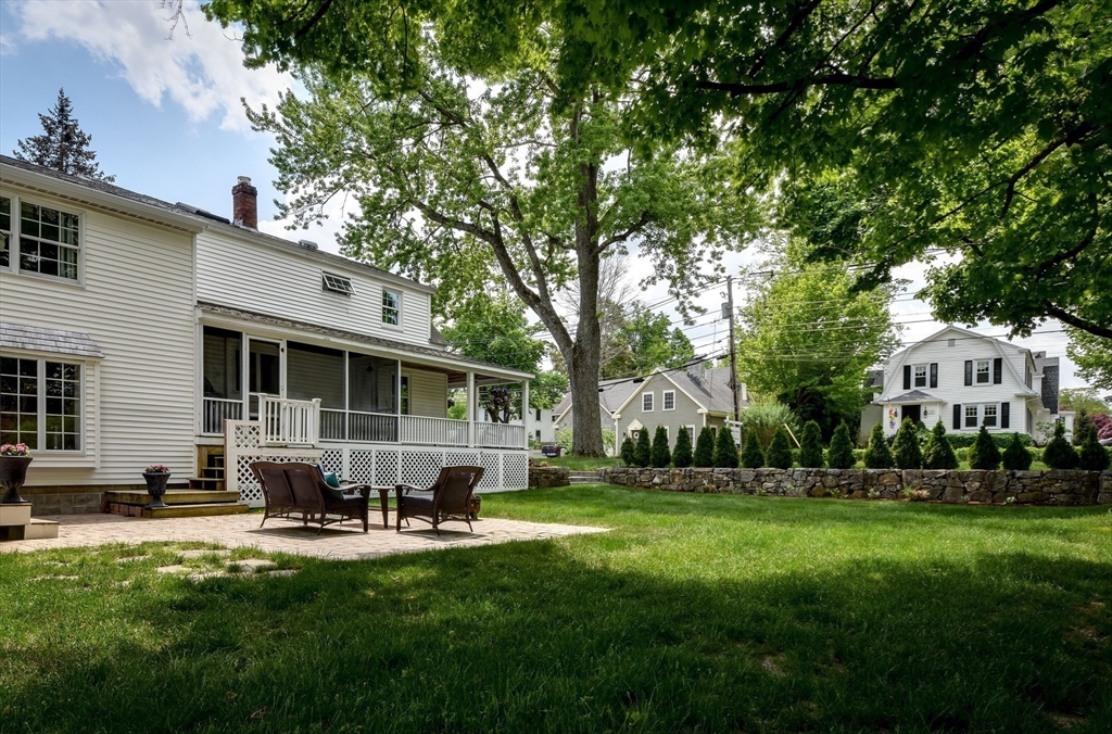49 Hayden Rowe Street Hopkinton, MA 01748 - Photo 34 of 39 a patio with table and chairs with plants and trees