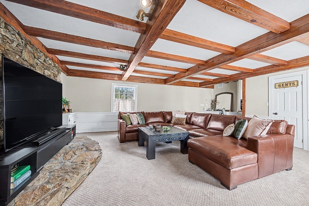 49 Hayden Rowe Street Hopkinton, MA 01748 - Photo 5 of 39 a living room with furniture a flat screen tv and a fireplace