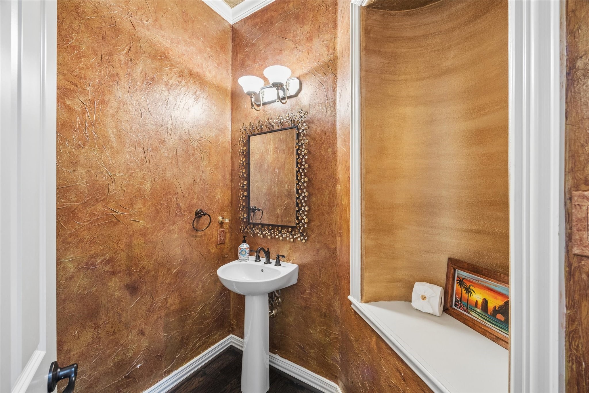 35 North Regent Oak Spring, TX 77381 - Photo 21 of 43 Conveniently located just off the main living areas, this elegant powder bath is perfectly suited for guests. Rich designer finishes, warm metallic tones, and custom decorative details create a sophisticated ambiance, adding a distinctive touch of character and style to the home.