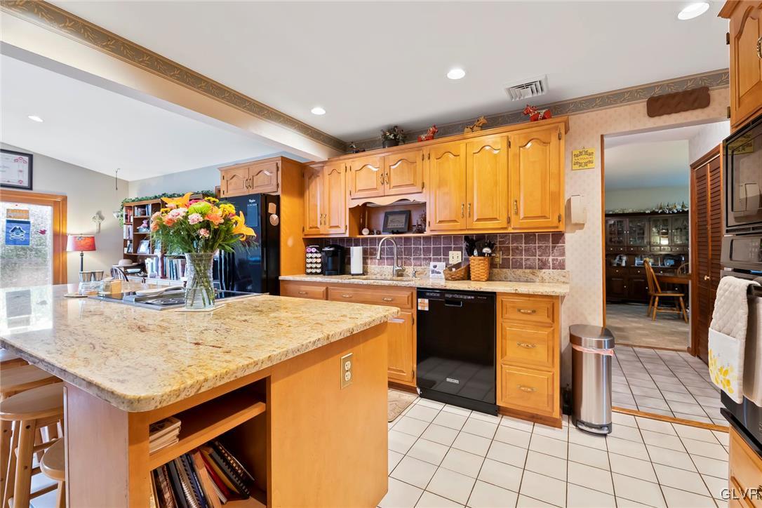 2744 Moore Circle Bath, PA 18014 - Photo 14 of 31 a kitchen with stainless steel appliances granite countertop a refrigerator a sink a stove and island