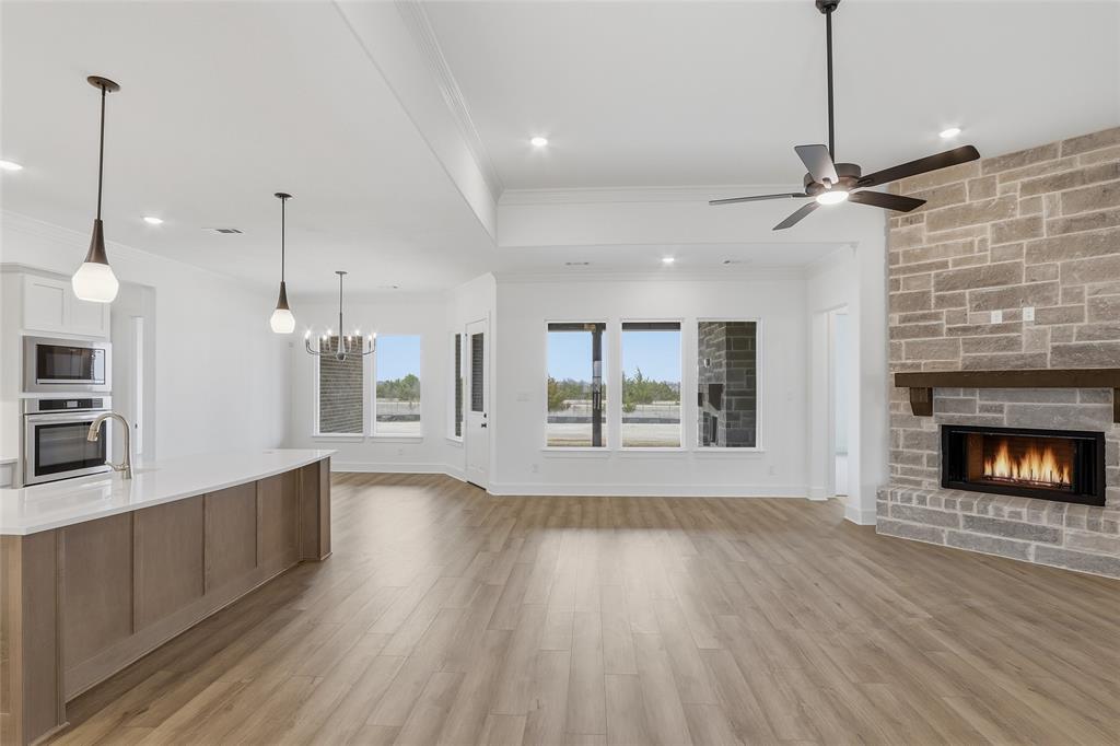 1005 Webb Court Van Alstyne, TX 75495 - Photo 10 of 38 a view of an empty room with window and wooden floor