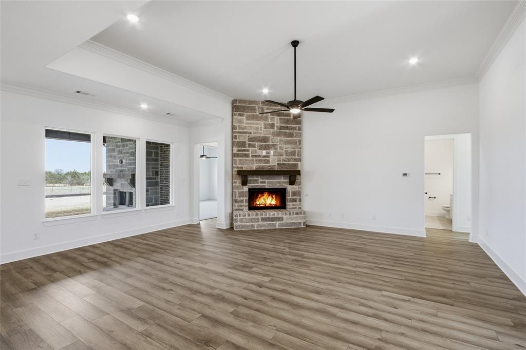 1005 Webb Court Van Alstyne, TX 75495 - Photo 12 of 38 a view of an empty room with a fireplace and a window