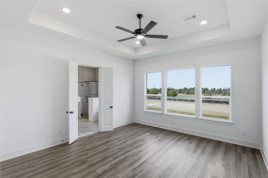 1005 Webb Court Van Alstyne, TX 75495 - Photo 17 of 38 an empty room with wooden floor and windows