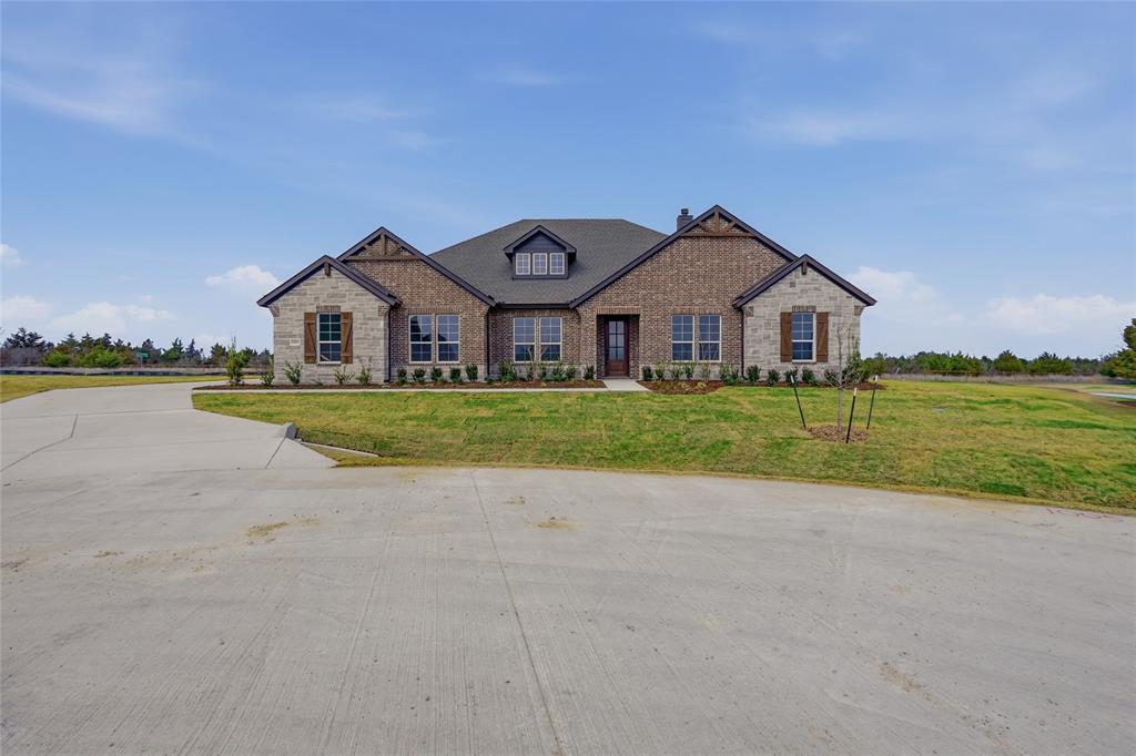 1005 Webb Court Van Alstyne, TX 75495 - Photo 2 of 38 a front view of a house with a big yard and potted plants