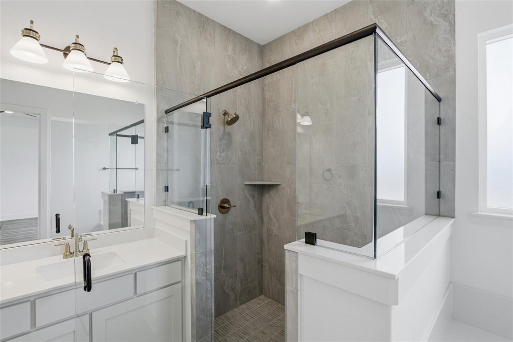 1005 Webb Court Van Alstyne, TX 75495 - Photo 20 of 38 a bathroom with a sink a toilet and shower