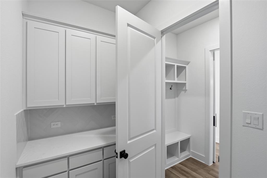 1005 Webb Court Van Alstyne, TX 75495 - Photo 23 of 38 a view of wooden cabinets