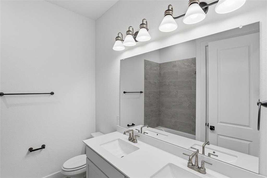 1005 Webb Court Van Alstyne, TX 75495 - Photo 26 of 38 a bathroom with a sink vanity granite and toilet