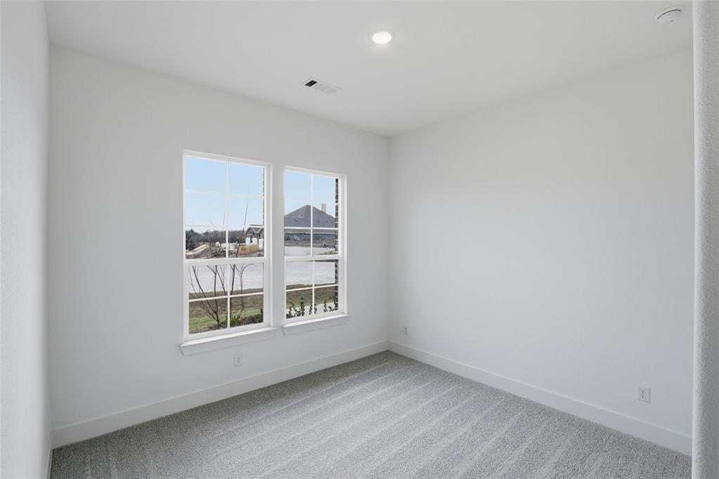1005 Webb Court Van Alstyne, TX 75495 - Photo 30 of 38 an empty room with windows