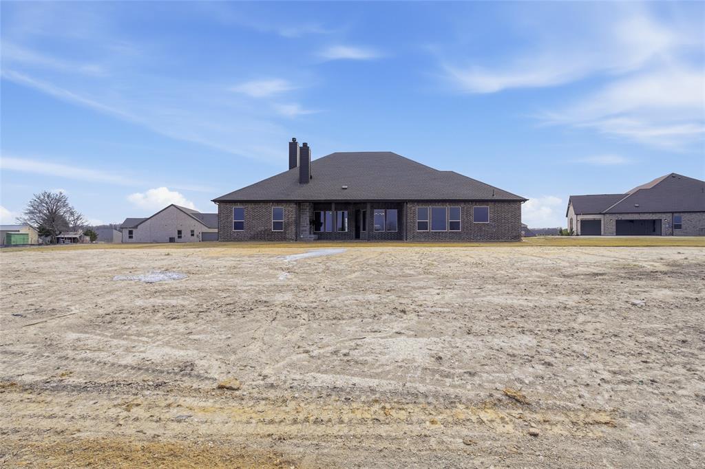 1005 Webb Court Van Alstyne, TX 75495 - Photo 34 of 38 a large house with a big yard and large trees