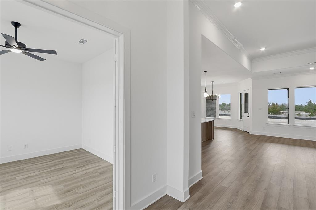 1005 Webb Court Van Alstyne, TX 75495 - Photo 7 of 38 a view of an empty room with wooden floor and a window