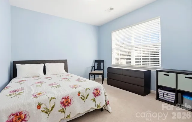 a bedroom with a bed and a table