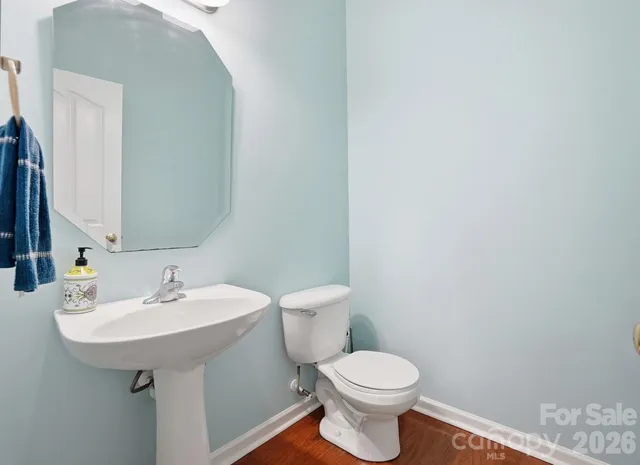 a bedroom with a bed chandelier and a window