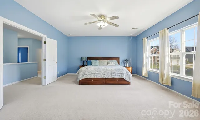 a bathroom with a tub sink double vanity and a mirror