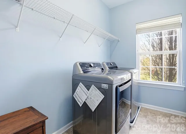 a bed room with furniture and window