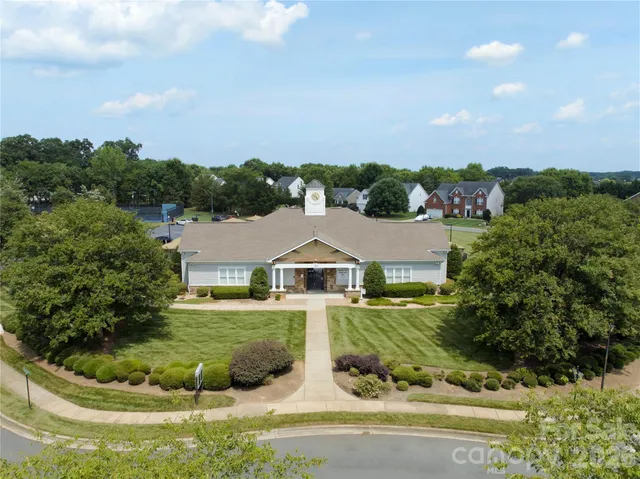 an aerial view of a house with swimming pool garden and outdoor seating