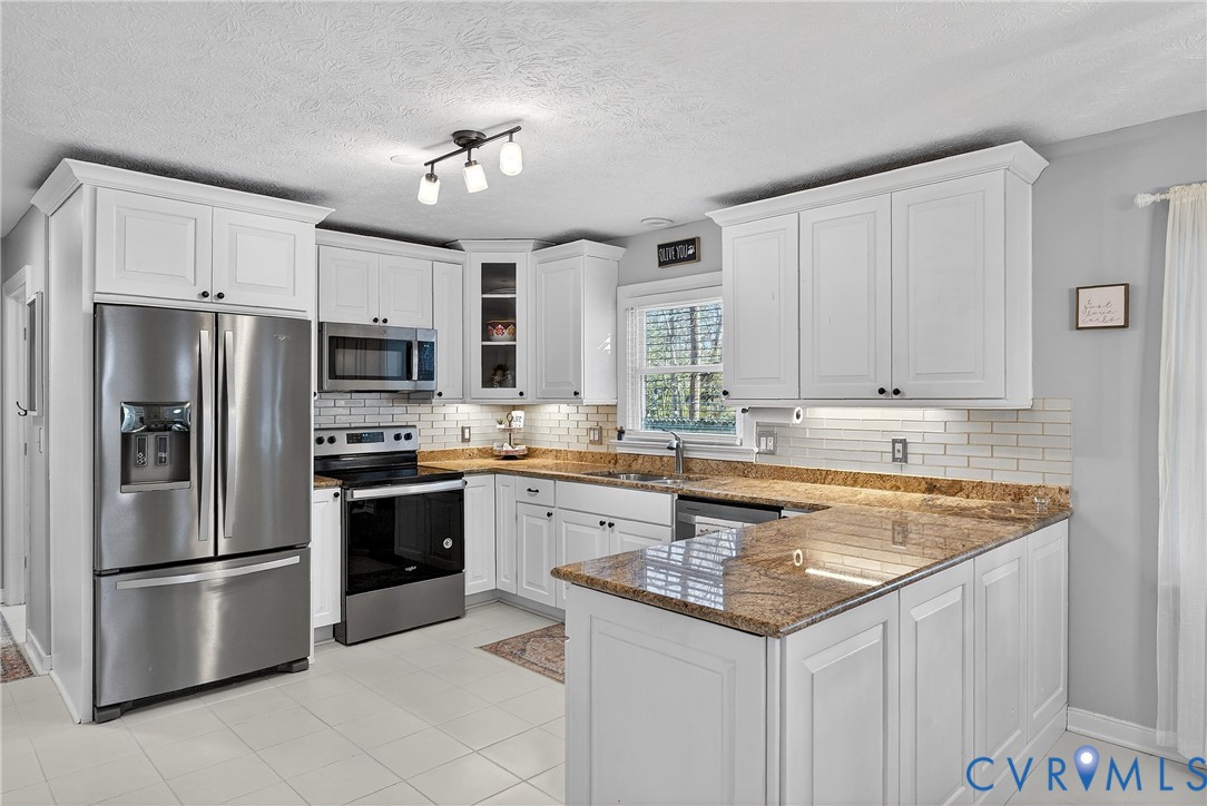 7443 Pinehurst Drive Quinton, VA 23141 - Photo 19 of 49 a kitchen with stainless steel appliances granite countertop a sink stove and refrigerator