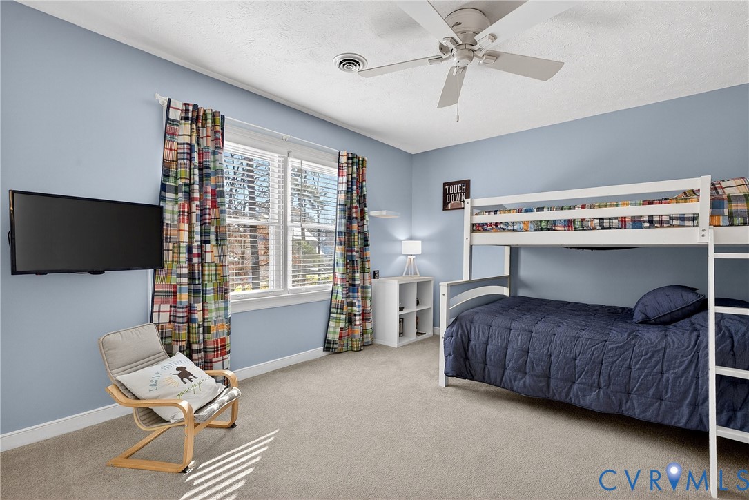 7443 Pinehurst Drive Quinton, VA 23141 - Photo 31 of 49 a bedroom with a bed and a chair