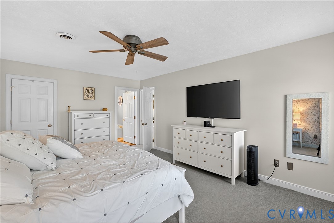 7443 Pinehurst Drive Quinton, VA 23141 - Photo 37 of 49 a bedroom with a bed and a flat screen tv