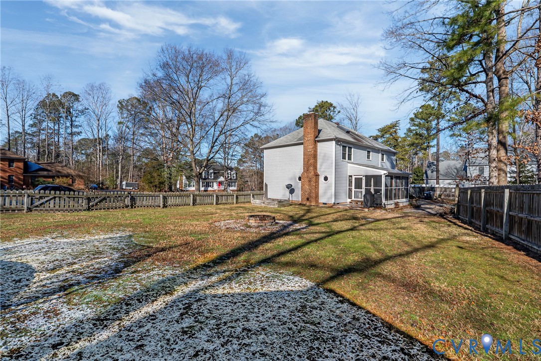 7443 Pinehurst Drive Quinton, VA 23141 - Photo 48 of 49 a view of a white house with a yard covered with snow and trees