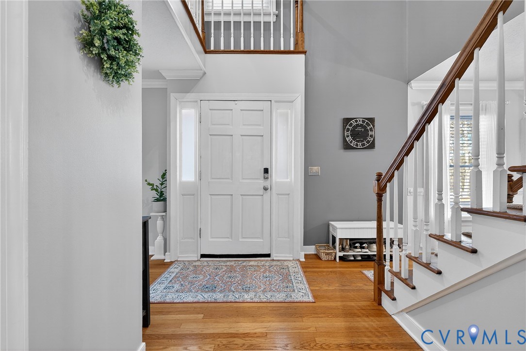 7443 Pinehurst Drive Quinton, VA 23141 - Photo 6 of 49 a view of an entryway with wooden floor and door