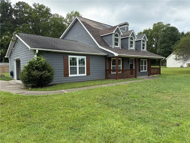 a front view of a house with a garden