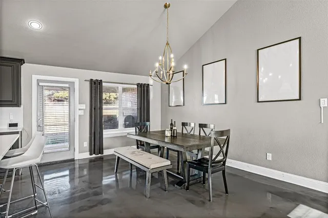 a view of a dining room with furniture and chandelier