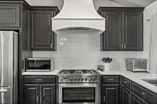 a large kitchen with a table and chairs