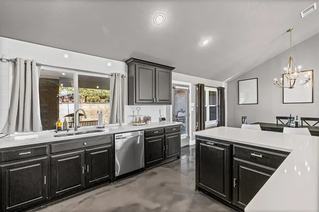 a kitchen with granite countertop a stove and a microwave