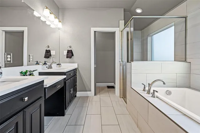 a spacious bedroom with a bed and a refrigerator