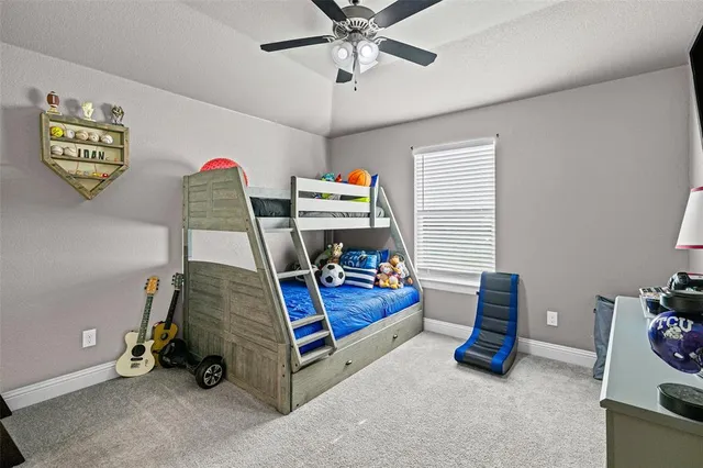 a bedroom with a bed and a flat tv screen on the dresser
