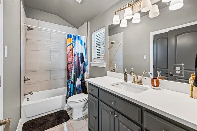 a bedroom with bed and a chandelier