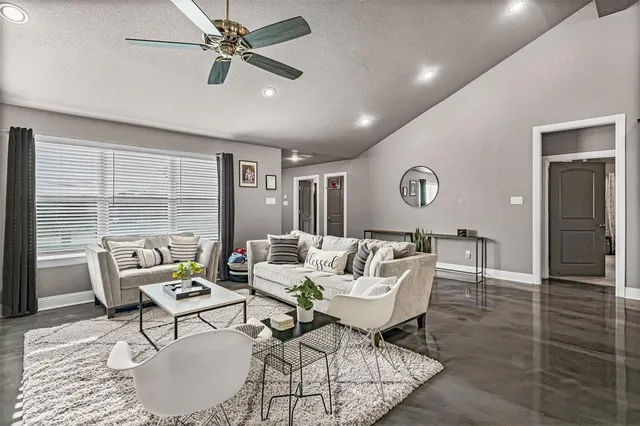 a living room with furniture and a large window