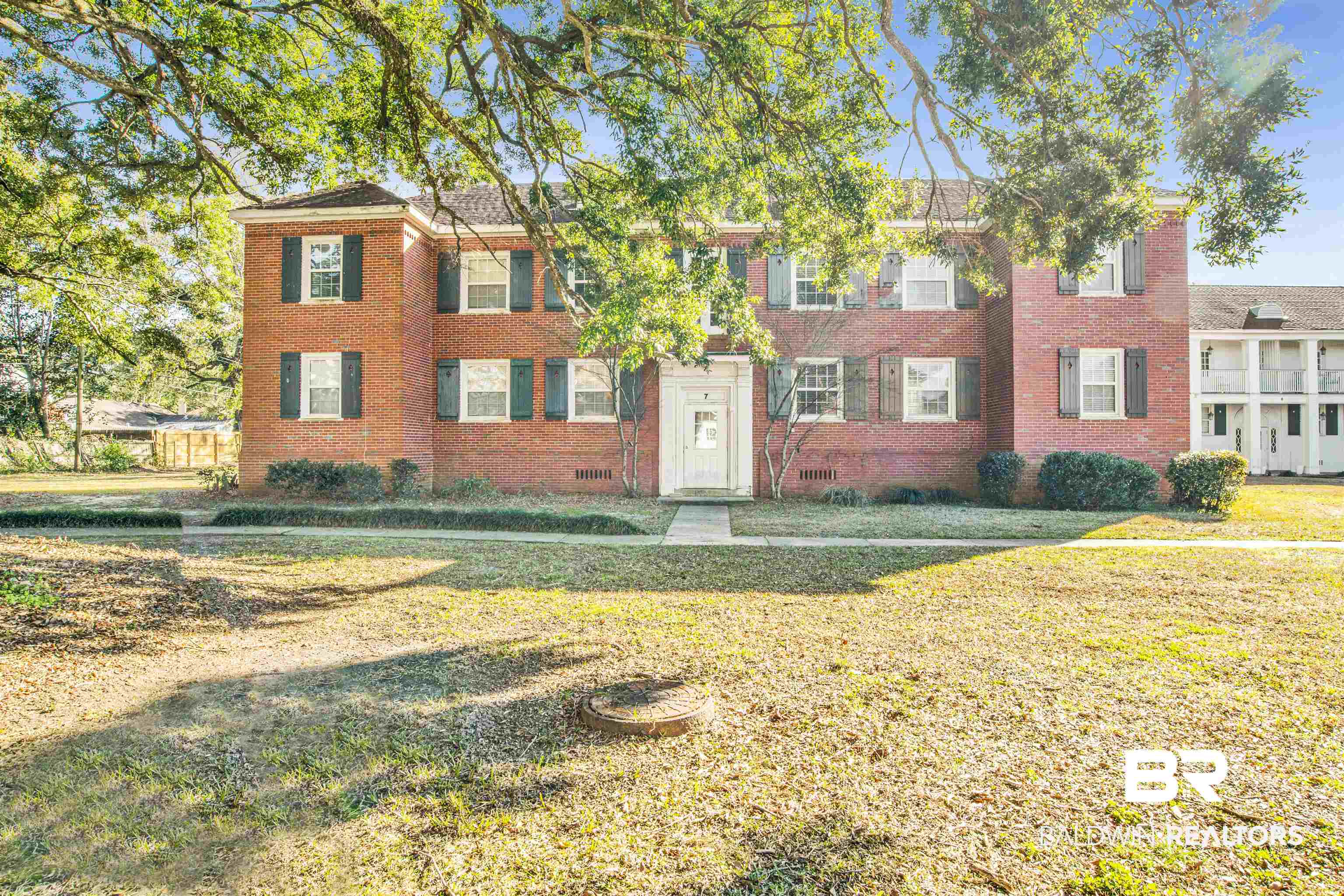 214 Upham Street, Unit 7A Mobile, AL 36607 - Photo 22 of 35 Colonial inspired home featuring brick siding and a front yard