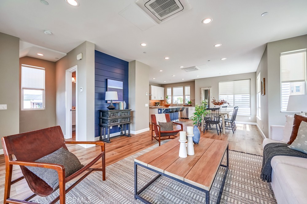 2125 Evans Way Costa Mesa, CA 92627 - Photo 11 of 41 a living room with furniture a dining table and a fireplace