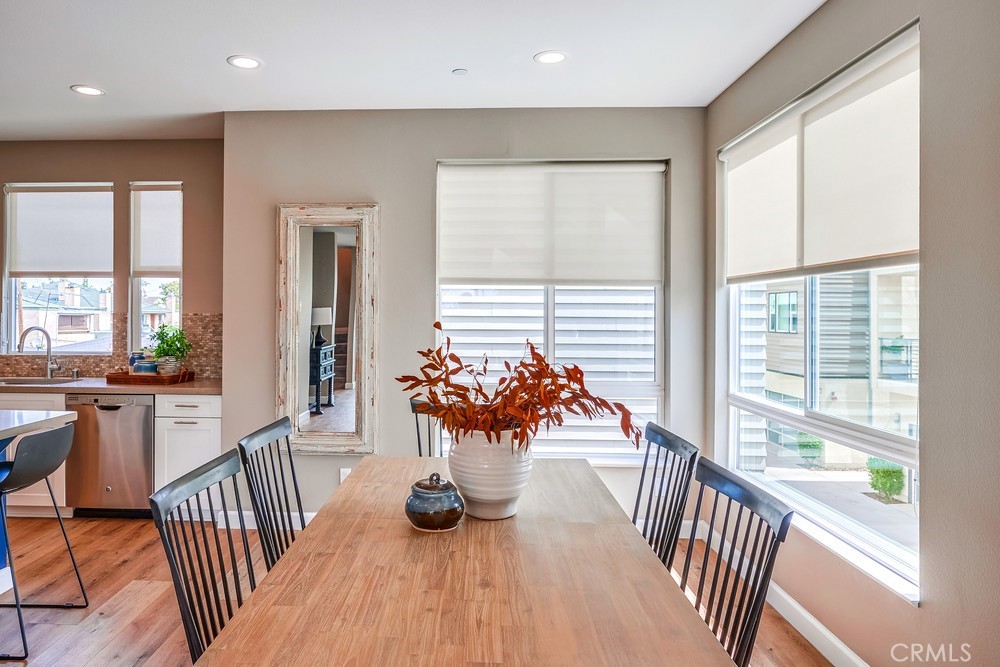 2125 Evans Way Costa Mesa, CA 92627 - Photo 14 of 41 a view of a dining room and hall with wooden floor