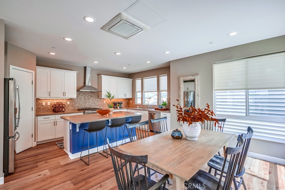 2125 Evans Way Costa Mesa, CA 92627 - Photo 15 of 41 a view of a dining room and livingroom with furniture window and wooden floor
