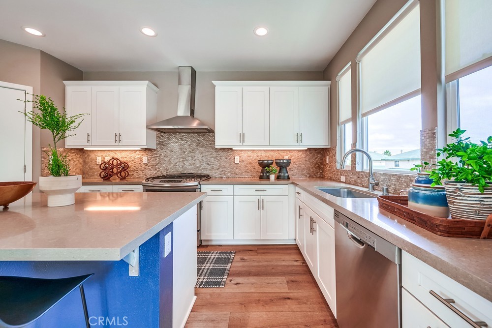 2125 Evans Way Costa Mesa, CA 92627 - Photo 17 of 41 a kitchen with stainless steel appliances granite countertop a sink a stove and a refrigerator