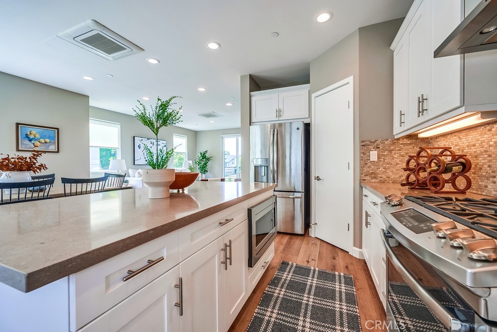 2125 Evans Way Costa Mesa, CA 92627 - Photo 19 of 41 a kitchen with stainless steel appliances a sink a stove a refrigerator and cabinets
