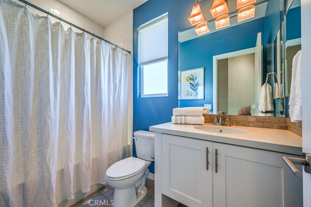 2125 Evans Way Costa Mesa, CA 92627 - Photo 28 of 41 a bathroom with a toilet sink and mirror