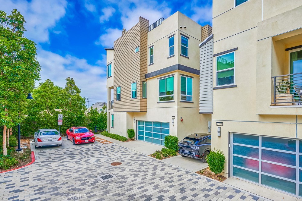 2125 Evans Way Costa Mesa, CA 92627 - Photo 3 of 41 a front view of a house with a yard and garage
