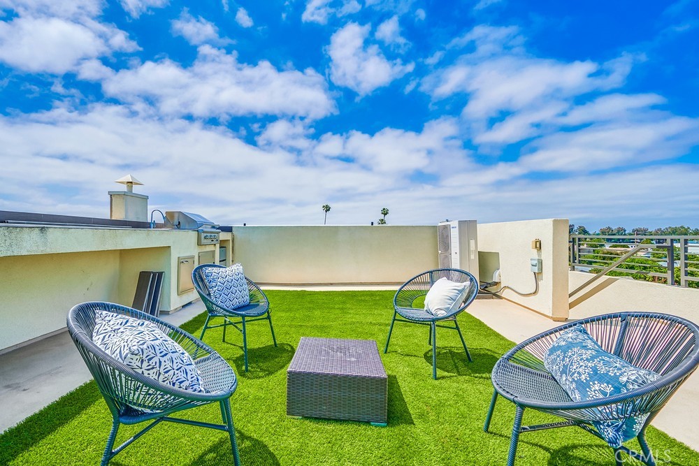 2125 Evans Way Costa Mesa, CA 92627 - Photo 34 of 41 a patio with a table and chairs