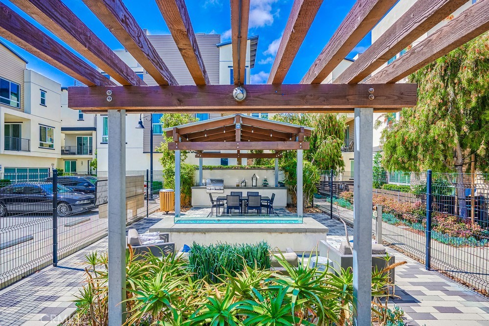 2125 Evans Way Costa Mesa, CA 92627 - Photo 39 of 41 a view of a patio with a table and chairs under an umbrella